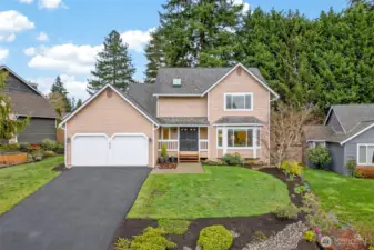 The front elevation shows the home’s timeless design, generous driveway approach, and two car garage, all framed by mature evergreens and attractive yard space. Buyers will appreciate the combination of privacy, presence, and a highly desirable English Hill location within the Northshore School District