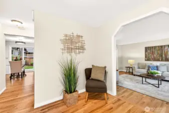 Inside, bright and welcoming spaces begin at the entry, where refinished hardwood floors help set the tone for the main level. The layout immediately feels functional and inviting, with a floorplan that balances openness and distinct living areas