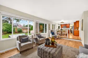 From here, the family room shows its comfortable scale and strong connection to the kitchen and informal dining area. This open relationship between the spaces makes the floorplan especially appealing for both daily life and entertaining.