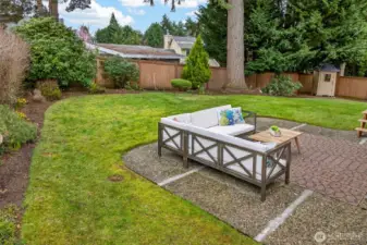 This patio area provides an inviting setting for outdoor meals, weekend gatherings, or quiet evenings at home. Its location within the fenced yard makes it feel connected, comfortable, and well defined.