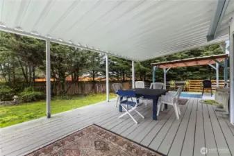 Covered deck that extends across the entire length of the house.