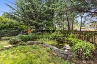 Cute fish pond in the back corner.