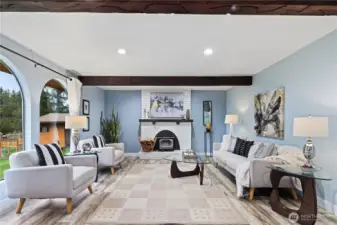 Beautifully updated, light-filled living room with cozy fireplace insert