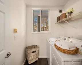 In-unit laundry room with storage space.