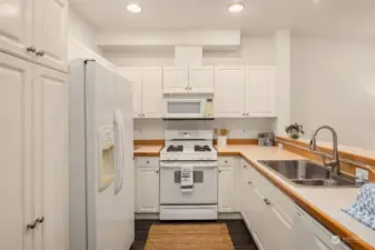 Kitchen provides ample prep and storage space, including pantry cabinet.