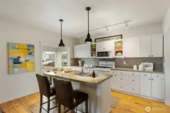 Whip up delicious memories in the kitchen with granite tile counters, crisp white cabinetry, and a breakfast bar.