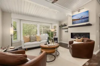 Light filled living room with a new and freshly serviced fireplace which warms the space nicely in the winter.