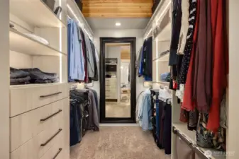 Very large walk in closet with thoughtful lighting lining every storage space.