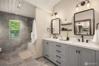 Dual vanity bathroom for the additional bedrooms, recently updated with floor to ceiling tile and a full dual mirror door closet to the left of photo!