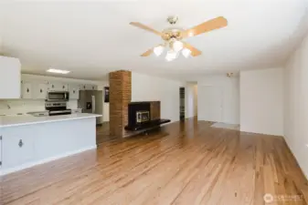 Great room with the remodeled kitchen on left and fireplace centered