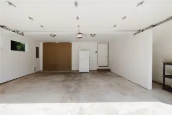 Two car garage is large with extra storage.