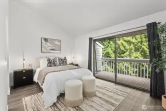 Peaceful primary bedroom with private deck access.