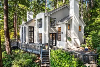 Large deck with privacy in a forest like setting for entertaining or relaxation. Convenient stairway access to yard and tram.