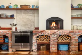 Wolf induction range with custom pop up downdraft ventilation system and leathered real stone Quartzite backsplash , Taj Mahal leathered finish.