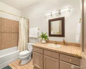 Ensuite guest bathroom with tub and shower combination.