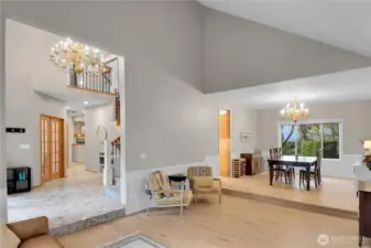 Formal living room with vaulted ceiling, LVP flooring and gas fireplace