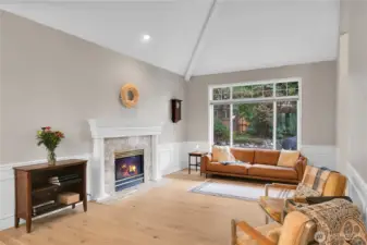 Formal living room with vaulted ceiling, LVP flooring and gas fireplace