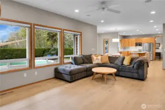 Family room with custom gas fireplace, wood built ins, and LVP flooring