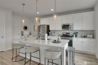 Kitchen island with pendant lights, pantry to the far left ~