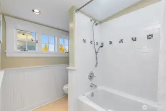 Spacious full bath with skylight over shower.