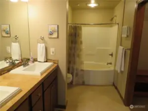Primary bath with two sinks, primary closet to the left.  Ceramic tile flooring and radiant heat in both bathroom floors.