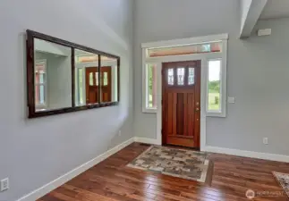 Grand entrance with hard wood and custom tile.