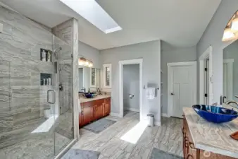 Ensuite bathroom boasts walk in shower w/ two heads, double sinks and walk in closet.
