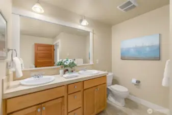 The primary suite includes a large full bathroom with both a walk-in shower and a soaking tub.