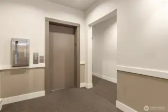 Conveniently located kitty-corner to the elevator, with easy access to the covered garage—no stairs required.