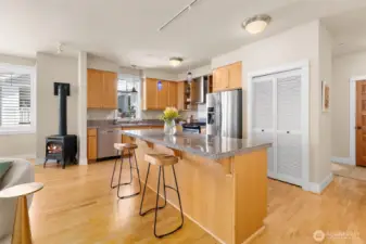 Modern kitchen featuring stainless steel appliances, well-maintained Craftsman-style cabinetry, and a functional layout that opens to the great room.