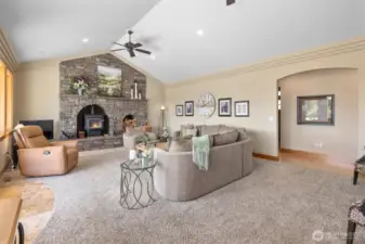 Off the kitchen is the living room with huge stone fireplace/hearth surround. This is a free standing fireplace that throws so much heat!!! Notice the coffered ceilings!!!