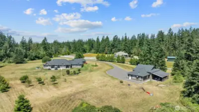 Full paved driveway and parking area for cars/RV. Park RV on inside of shop or on the outside. RV dump by walk-thru door and 30 amp electrical on other side of shop for more RV parking area!