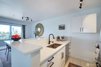 New cabinets, countertops and hardware. Sink has a garbage disposal.