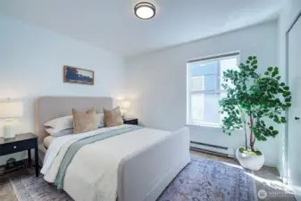 Primary bedroom staged with a queen size bed.