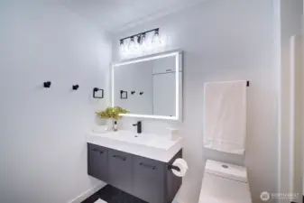Bathroom updated with floating vanity, new lighting and LED, fog-free mirror.