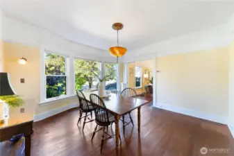 Isn't that light fixture exceptional?  The large formal dining room is situated between the living room and kitchen space.  The Kitchen is behind and the living room space is through the doorway near the windows.