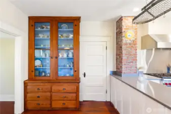 Look at the floor to ceiling original built-in Buffett!  It is one-of-a-kind and adds so much character to the room.  You can see the dining room on the left through the doorway.