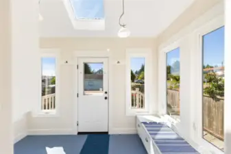 Happy, light, bright Utility/Sun Room with access to the deck and secluded park like grounds.