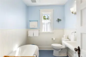 Look at this sweet bathroom!  There is a heating panel on the ceiling to keep you toasty warm. This is the original claw foot tub with other built ins.