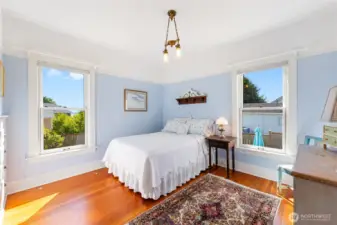 Main level bedroom with period light fixtures, push button switches and built in Dresser Drawers on the left.