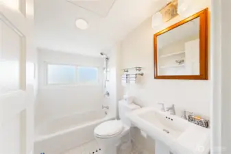Clean, white and bright upper level Bathroom.  Overhead heating panel to keep you warmed up.