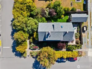 Situated perfectly for a Master Gardner who want to walk to town and have privacy.  Look at all the extra parking space off the alley.  You could easily park an RV, Truck or Boat in that space that currently has a Utility Trailer parked.  There is another private seating area in the front yard corner near the the front Porch.