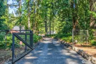 Gate and circular driveway welcome you.