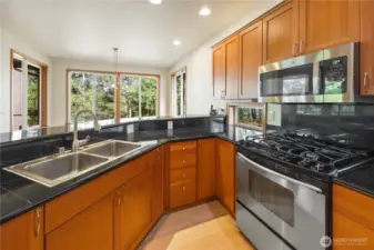 Efficient kitchen.  Note the windows under the cabinets.  Eating bar.