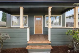 Front porch has been updated with pressure treated lumber, wrapped posts.