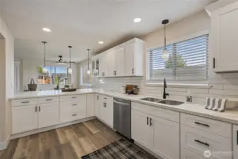 Chef's kitchen with quartz countertops, classic subway tile.
