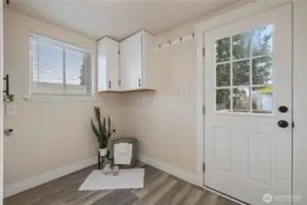 Utility/mudroom opens to backyard deck & 2 car garage