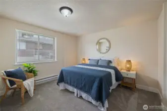 Primary bedroom with ample closet space & new carpet