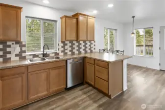 Open kitchen with eating bar and looking into the dining room.