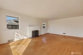 Picture hardwood floors restored to a gleaming finish, built-in shelving around the fireplace - l